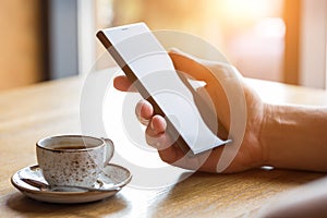 Close up of man`s hands holding mobile smart phone