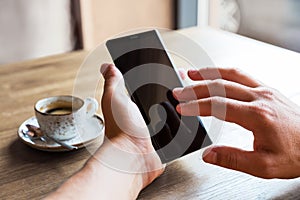 Close up of man`s hands holding mobile smart phone