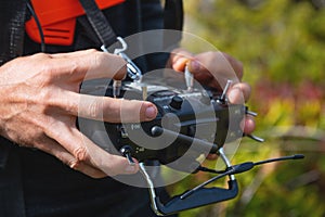 Close-up of a man& x27;s hands holding a transmitter and control equipment for an FPV drone quadcopter. Drone control