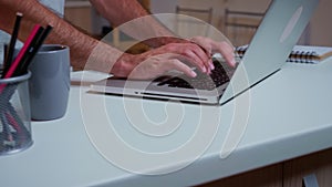 Close up of man`s hands typing on laptop