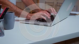 Close up of man`s hands typing on laptop