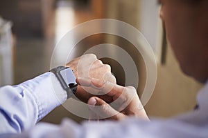 Close up of mans hands using smartwatch