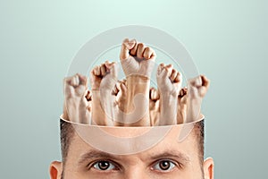 Close-up of a man`s head instead of a brain, fists raised up. The concept of fighting for their rights, labor movement, electoral