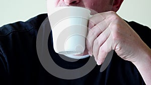 Close up of Man`s mouth drinking cup of milk