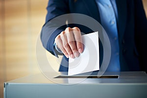 Close up of man\'s putting election vote paper into balloting box