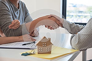 Close up man shaking hand with real estate agency