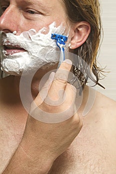 Close-Up Of Man Shaving Face