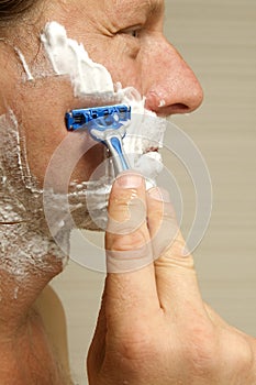 Close-Up Of Man Shaving His Face