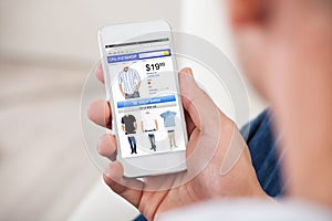 Close-up Of Man Shopping Online On Smartphone