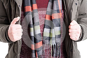 Close-up of man showing comforter sweater and jacket