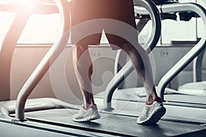 Close up. Man in Sneakers on Treadmill in Gym.