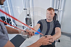 Close-up man on specialized decompression simulator at rehab clinic