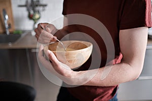 Close up of a man stirring egg yolks