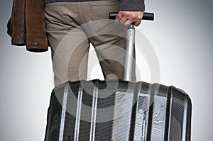 Close-up of a man with suitcase isolated on dark