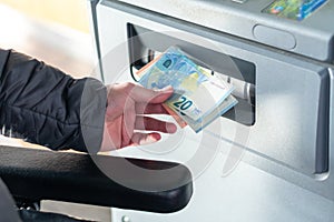 Close up of man taking cash, euros from ATM
