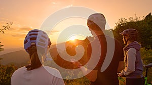 CLOSE UP: Man talking about the countryside to his friends during a bike trip.