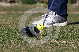 Close up of man teeing off at golf tournament