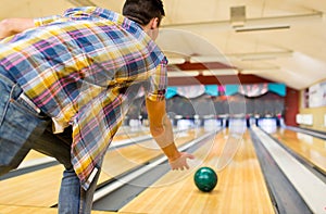 Close up of man throwing ball in bowling club