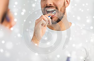 Close up of man with toothbrush cleaning teeth