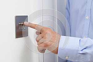 Close Up Of Man Turning Off Light Switch