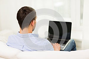 Close up of man typing on laptop computer at home