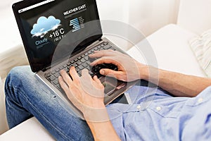 Close up of man typing on laptop computer at home