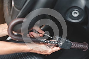 Close up of man use key locking steering wheel for security, Anti thief steal a car, Selective focus