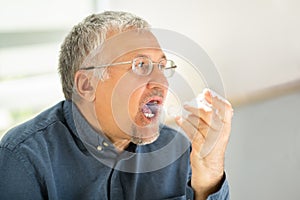 Man Using Asthma Inhaler