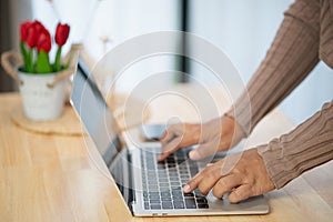 Close Up man using laptop online shopping with laptop, Online payment at home or office, internet banking, young people future