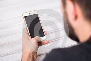 Close up of a man using mobile smart phone