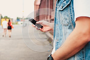 Close up of a man using mobile smart phone.