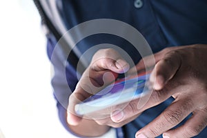 Close up of a man using mobile smart phone.