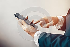 Close up of a man using mobile smart phone