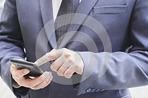 Close up of a man using mobile smart phone