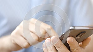 Close up of a man using mobile smart phone