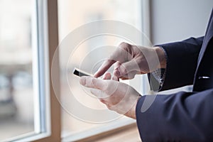 Close up of a man using mobile smart phone