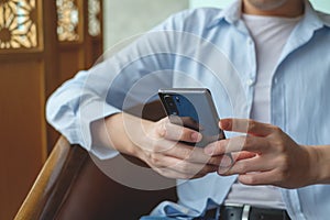 Close up of a man using mobile smart phone.