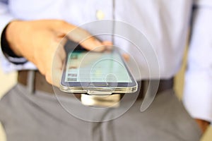 Close up of a man using mobile smart phone