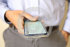 Close up of a man using mobile smart phone