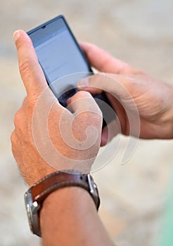 Close up of a man using mobile smart phone