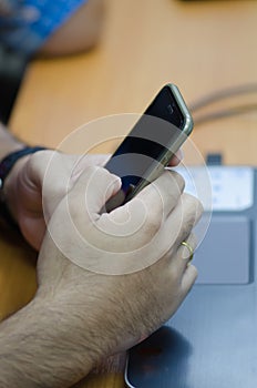 Close up of a man using mobile smart phone