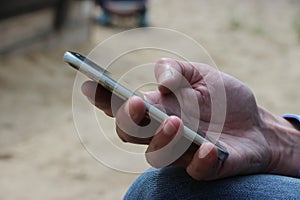 Close up of a man using mobile smart phone. Communication business concept