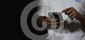 Close up of a man using mobile smart phone and copy space