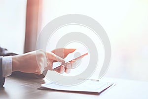 Close up of a man using mobile smart phone in the office