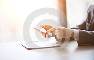 Close up of a man using mobile smart phone in the office