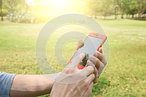 Close up of a man using mobile smart phone outdoor