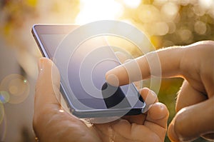 Close up of a man using mobile smart phone outdoor