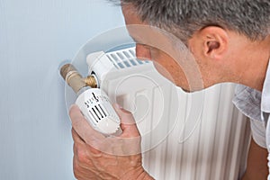 Close-up of a man using radiator