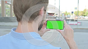 Close Up of Man Using Smartphone with Green Screen Outdoor