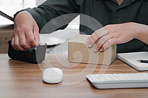 Close up Man using transparent masking tape packing